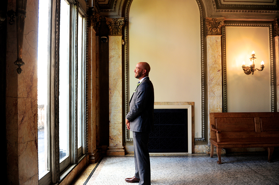 groom waiting for first look at library