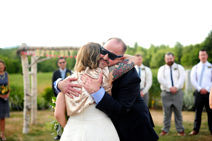 tattooed bride hugging her dad