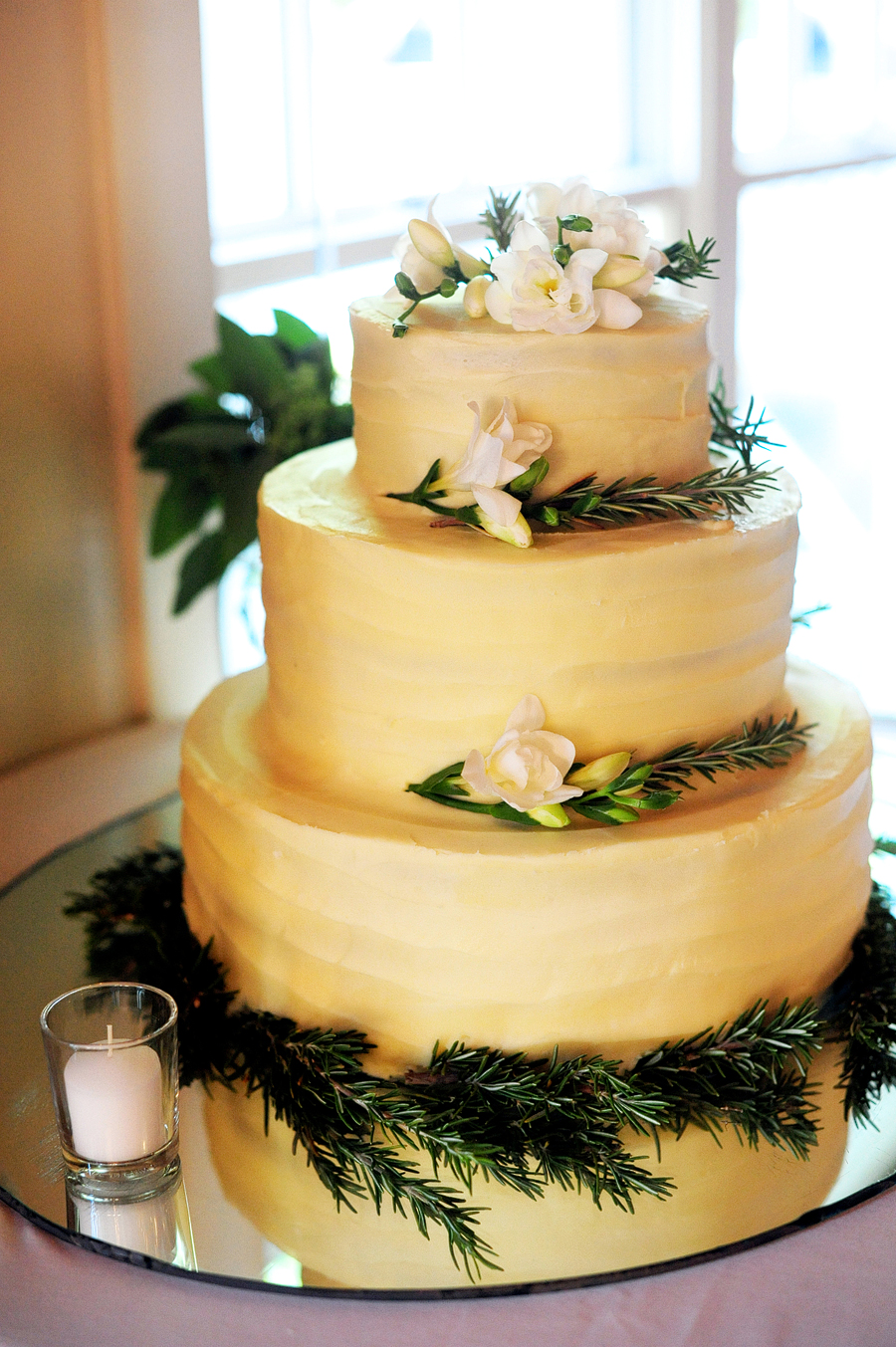 three tier wedding cake with simple flowers